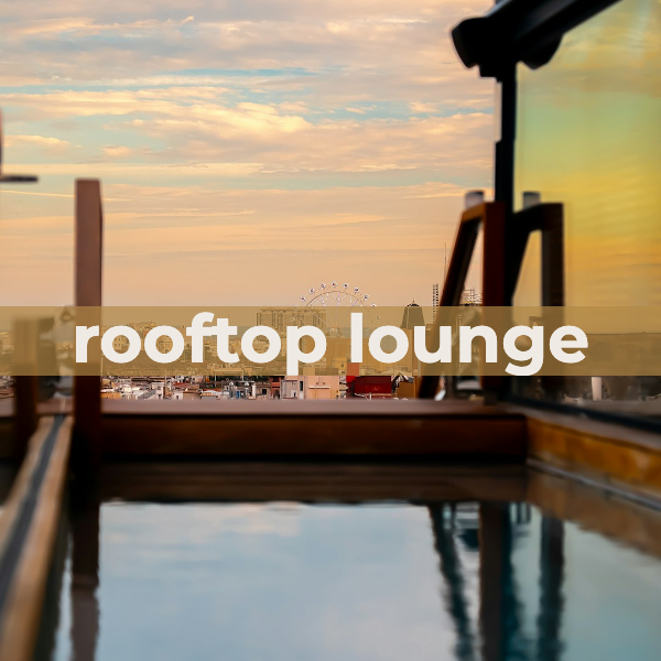 Rooftop lounge at golden hour overlooking a city skyline